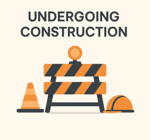 A flat vector illustration showing a website under construction. It includes a striped orange-and-black barricade with a warning light, an orange traffic cone, and a construction helmet. The text above reads 'UNDERGOING CONSTRUCTION'